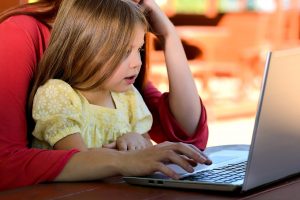 children-learning-online-during-lockdown-for-home-schooling-with-parents